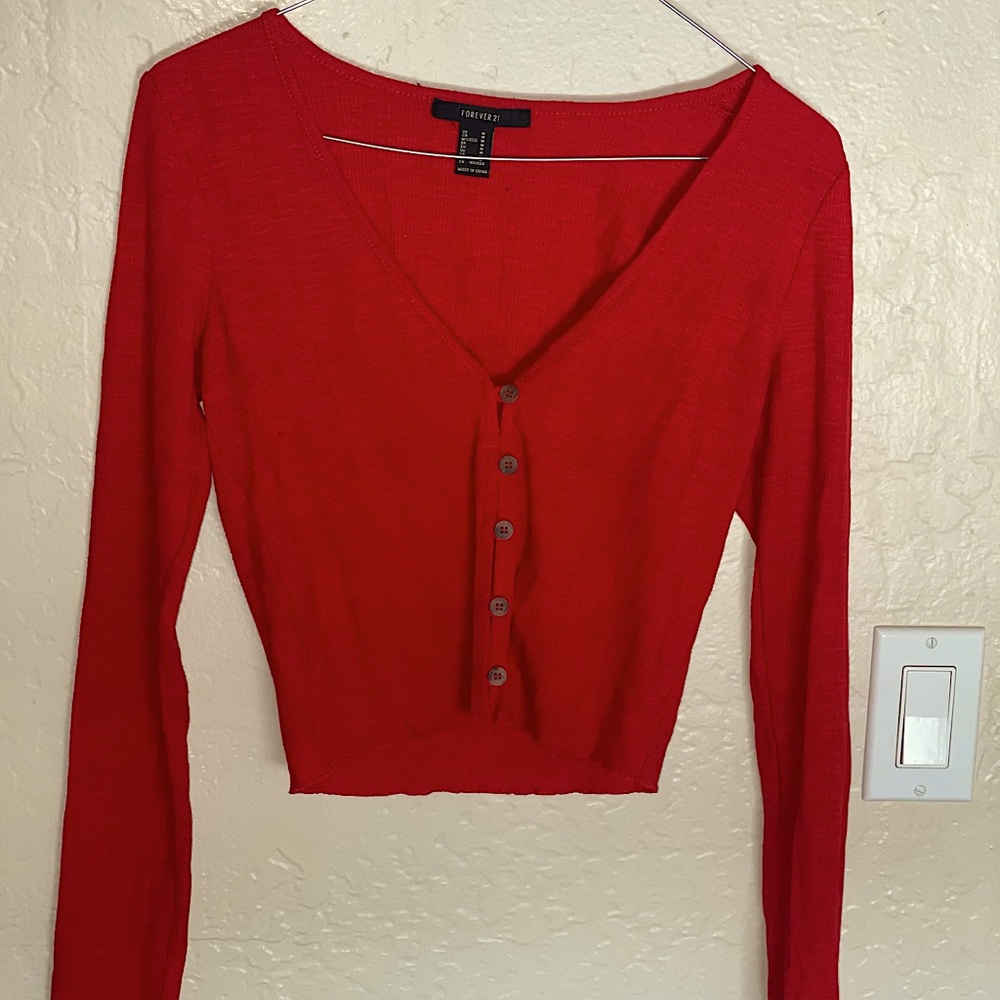 Red, long sleeve, button up crop top from forever 21. Medium size fitting.